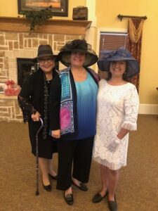 ladies in hats and gloves at Centennial Tea