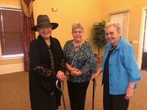 ladies in hats and gloves at Centennial Tea