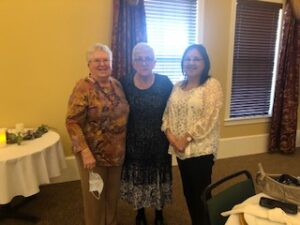ladies in hats and gloves at Centennial Tea