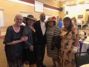 ladies in hats and gloves at Centennial Tea