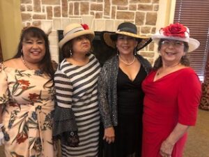 ladies in hats and gloves at Centennial Tea