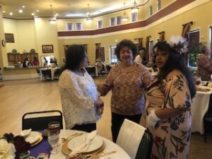ladies in hats and gloves at Centennial Tea