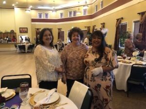 ladies in hats and gloves at Centennial Tea