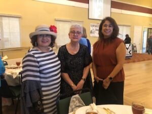 ladies in hats and gloves at Centennial Tea