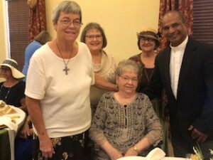 ladies in hats and gloves at Centennial Tea