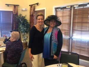 ladies in hats and gloves at Centennial Tea