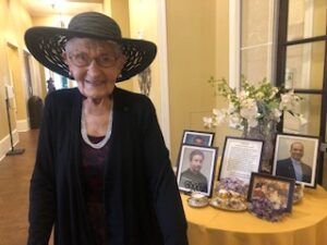 woman in hat next to table display