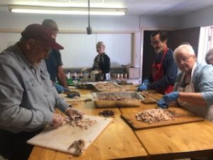 volunteers carving turkey at the 2021 Turkey Dinner Fundraiser