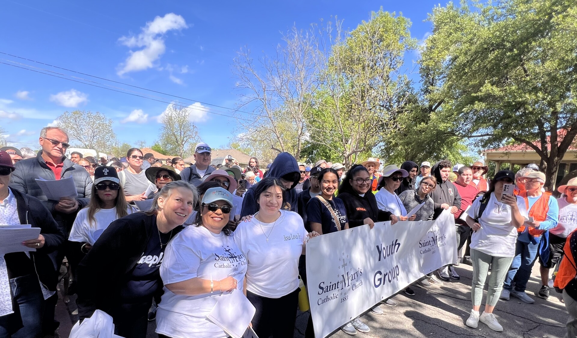 St. Mary's youth group holding a banner outdoors